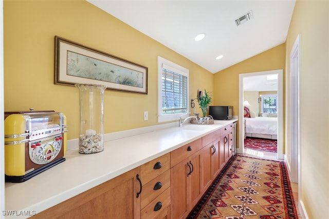 interior space with lofted ceiling and vanity