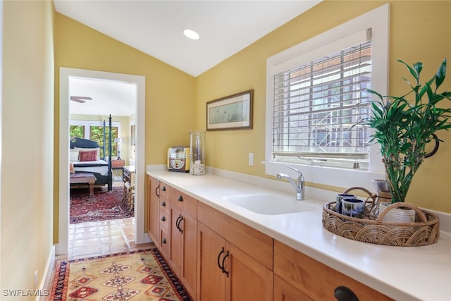 bathroom with lofted ceiling, vanity, and tile patterned flooring