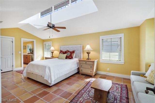 bedroom with tile patterned flooring, lofted ceiling, ceiling fan, and ensuite bathroom