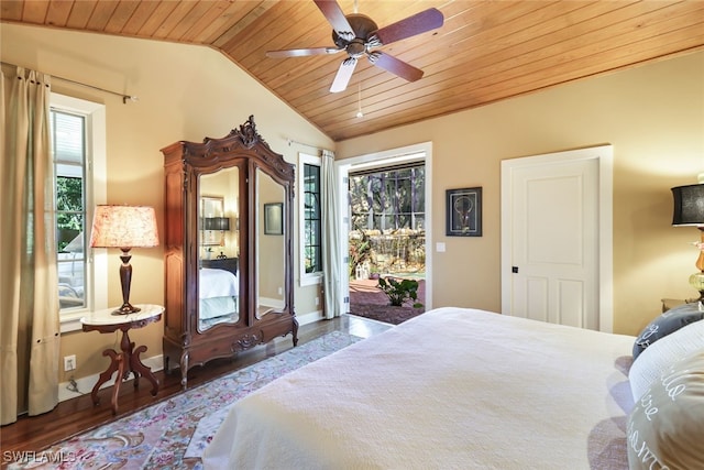 bedroom featuring multiple windows, lofted ceiling, and dark hardwood / wood-style floors