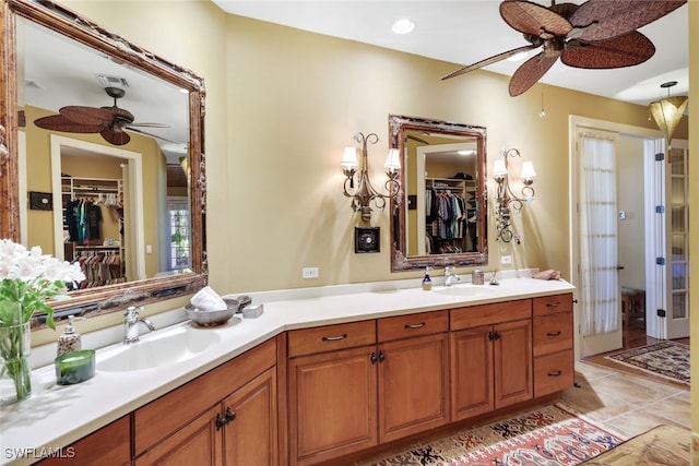 bathroom with tile patterned flooring, ceiling fan, and vanity