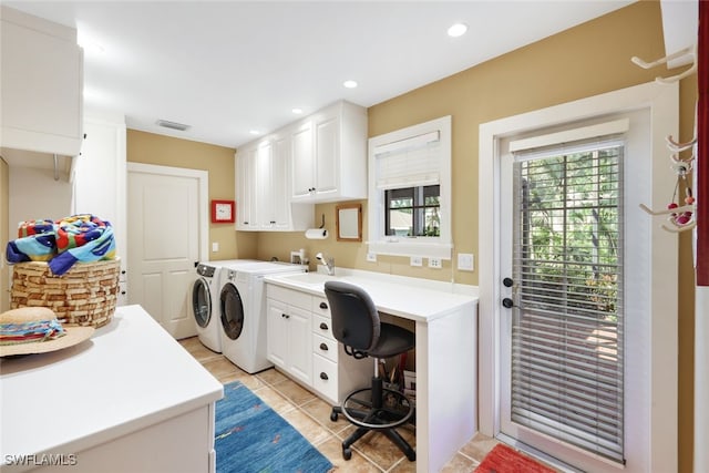 laundry area with washer and clothes dryer, cabinets, sink, and light tile patterned floors