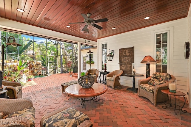 sunroom / solarium with wood ceiling and ceiling fan