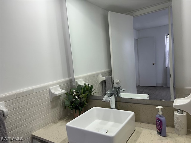 bathroom with tile walls and sink