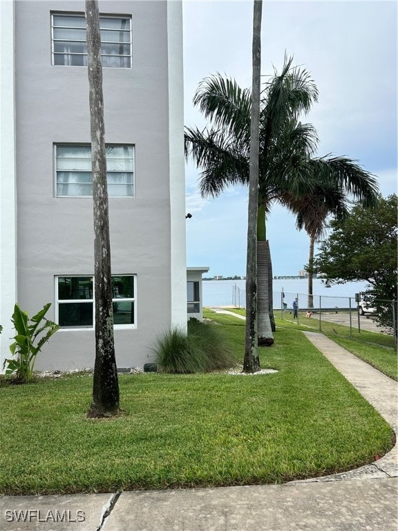 exterior space featuring a yard and a water view