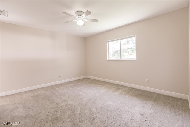 empty room featuring ceiling fan and carpet floors