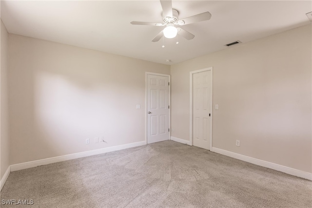 carpeted empty room featuring ceiling fan