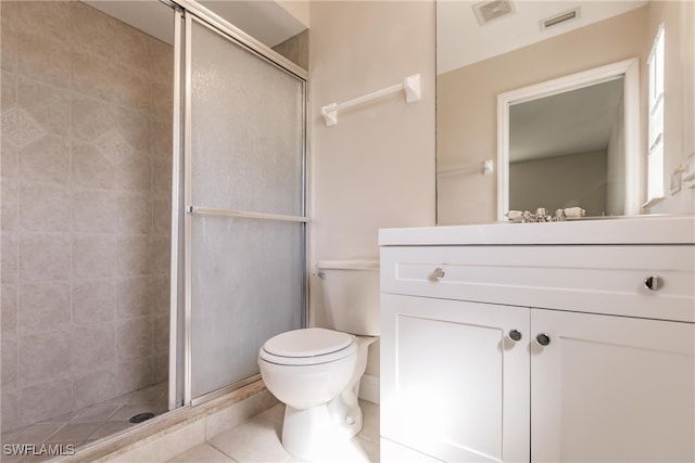 bathroom featuring tile patterned flooring, walk in shower, vanity, and toilet