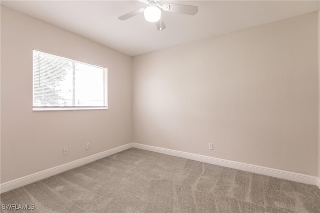 carpeted spare room featuring ceiling fan