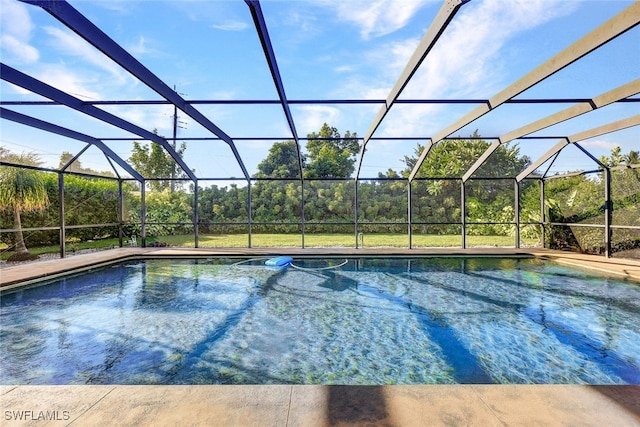 view of swimming pool featuring a lanai