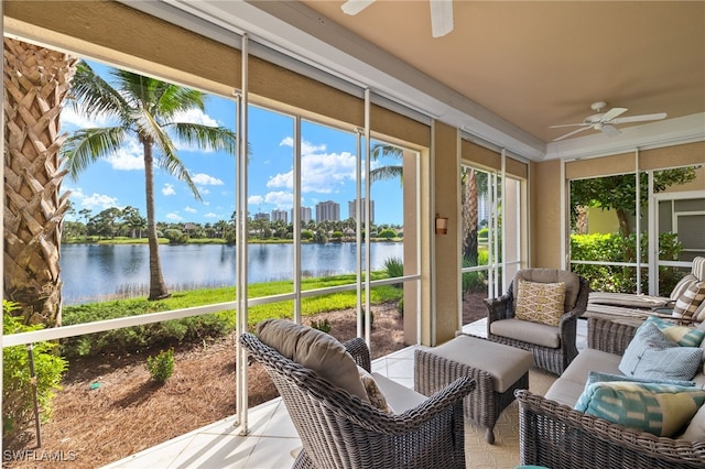 sunroom with a water view and ceiling fan