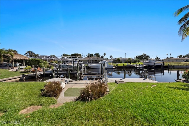 view of dock with a water view and a lawn