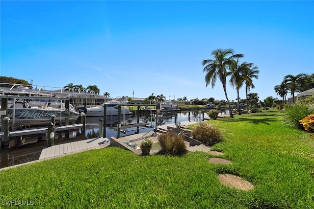 dock area with a water view and a lawn