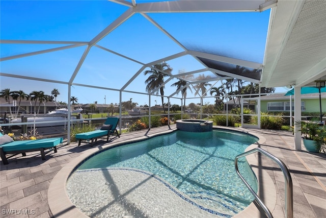 view of pool featuring an in ground hot tub, a patio area, and a lanai