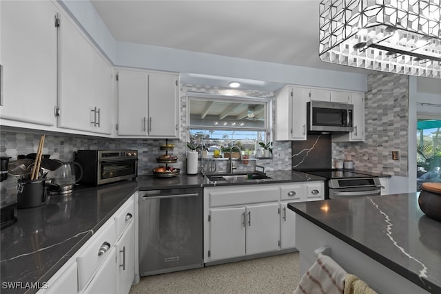 kitchen featuring white cabinetry, a healthy amount of sunlight, and stainless steel appliances