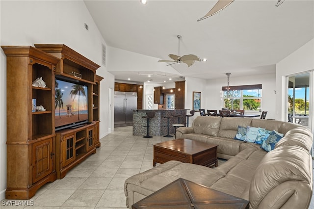 tiled living room featuring ceiling fan and lofted ceiling