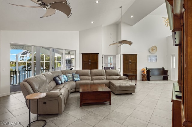 living room featuring ceiling fan, light tile patterned flooring, and high vaulted ceiling