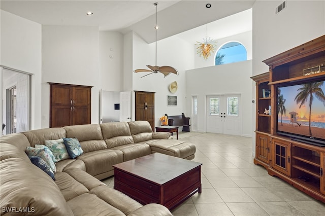 living room with ceiling fan, high vaulted ceiling, and light tile patterned flooring