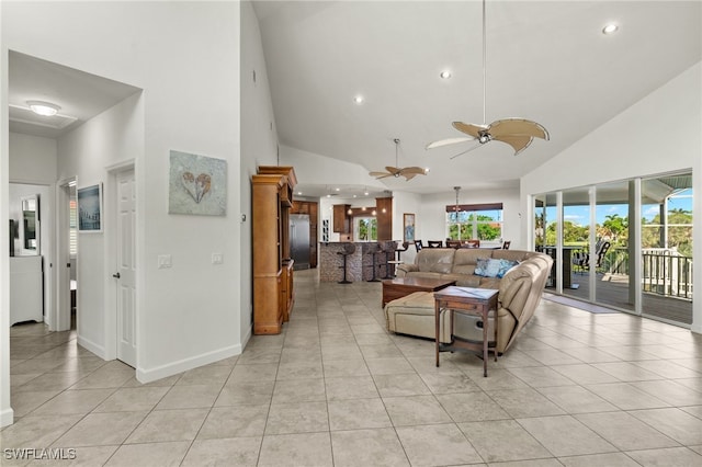 living room with ceiling fan, light tile patterned floors, and high vaulted ceiling