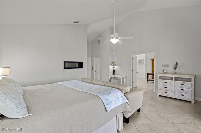 bedroom with ceiling fan, light tile patterned flooring, and high vaulted ceiling