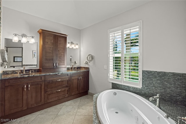 bathroom featuring vanity, a tub to relax in, tile patterned floors, and a wealth of natural light