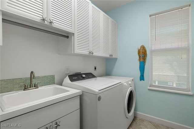 washroom with washer and dryer, cabinets, light tile patterned floors, and sink