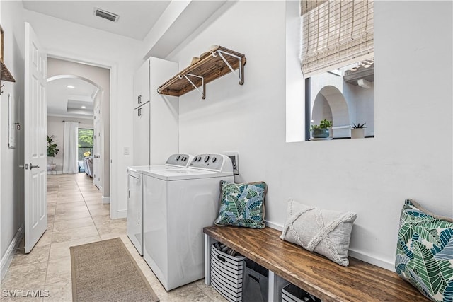 clothes washing area with light tile patterned floors and washing machine and clothes dryer