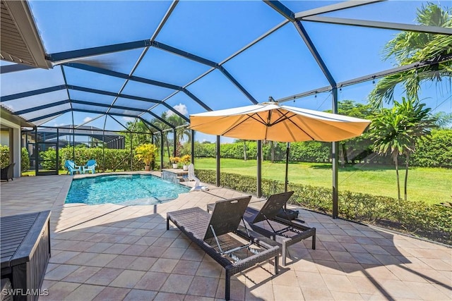 view of swimming pool with a lanai, a patio, and a lawn