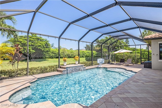 view of swimming pool with a lanai, pool water feature, and a patio area