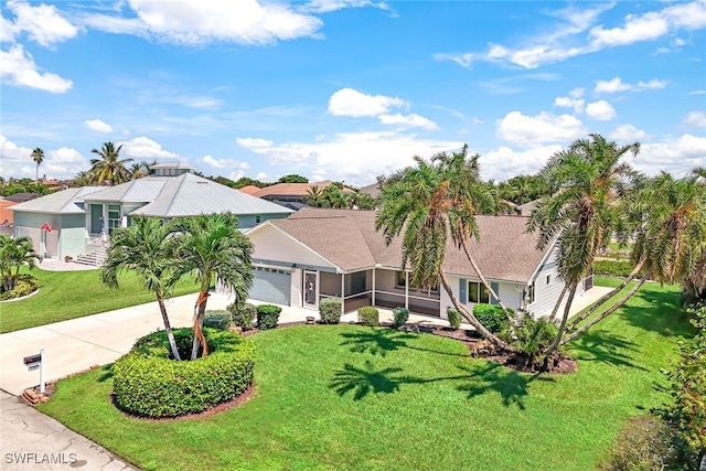 view of front of home with a garage and a front lawn