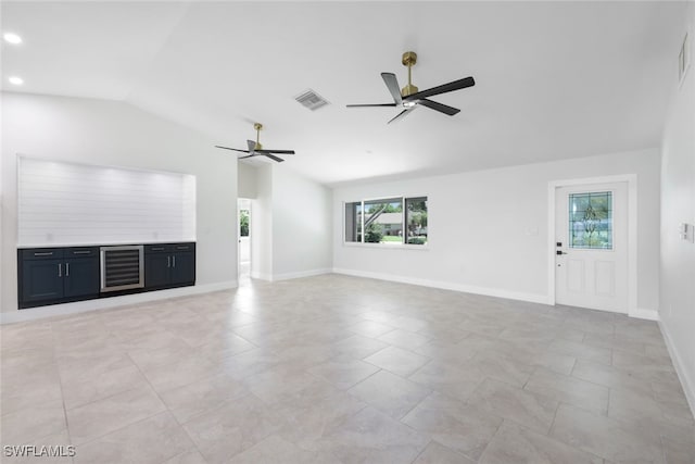 unfurnished living room featuring light tile patterned floors, lofted ceiling, ceiling fan, and a healthy amount of sunlight