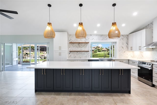 kitchen with stainless steel electric range, white cabinets, a center island, ceiling fan, and sink