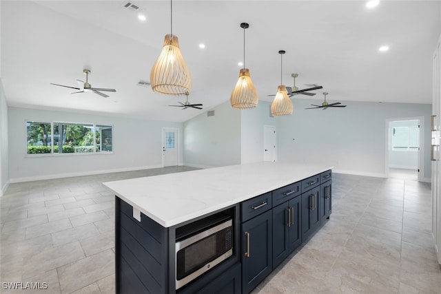 kitchen featuring ceiling fan, decorative light fixtures, and lofted ceiling