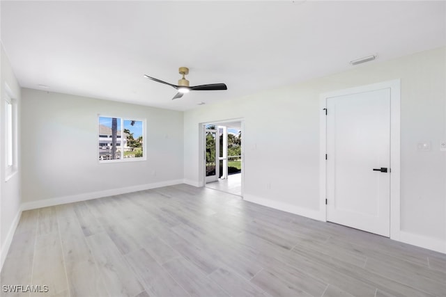 spare room with light hardwood / wood-style floors and ceiling fan