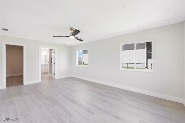 unfurnished room with light hardwood / wood-style floors, ceiling fan, and a wealth of natural light