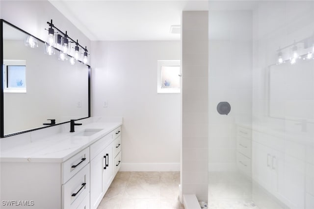 bathroom featuring vanity and tiled shower