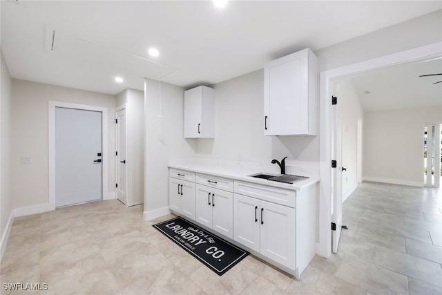 kitchen with white cabinetry and sink