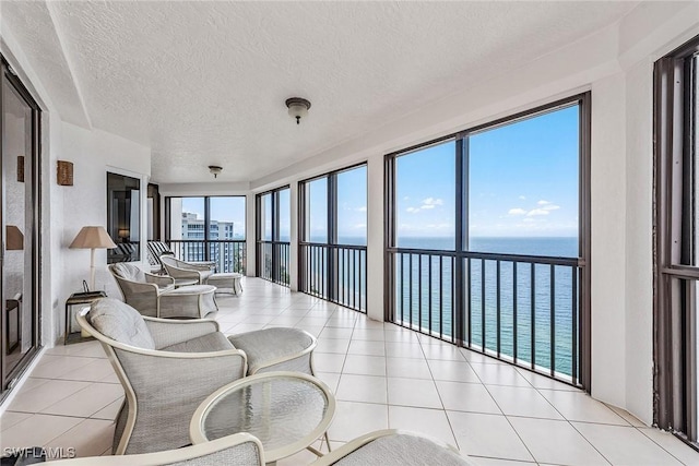 8171 Bay Colony Dr Unit 2004, Naples, FL 34108 - sunroom with a water view, tile patterned floors, and a textured ceiling