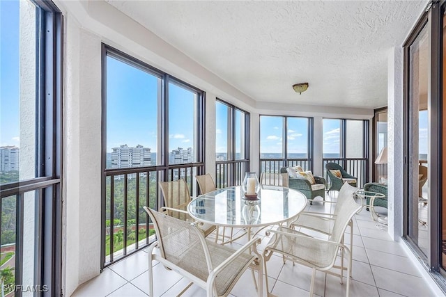 8171 Bay Colony Dr Unit 2004, Naples, FL 34108 - sunroom / solarium with tile patterned flooring, plenty of natural light, a city view, a textured ceiling, and a water view