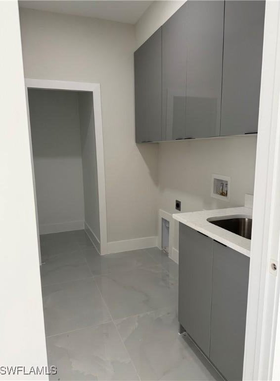 washroom with cabinets, washer hookup, hookup for an electric dryer, and sink