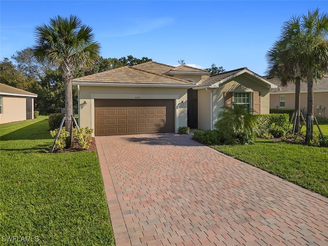 single story home featuring a front lawn and a garage