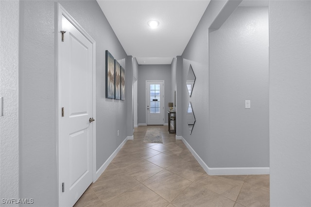 hallway with light tile patterned floors