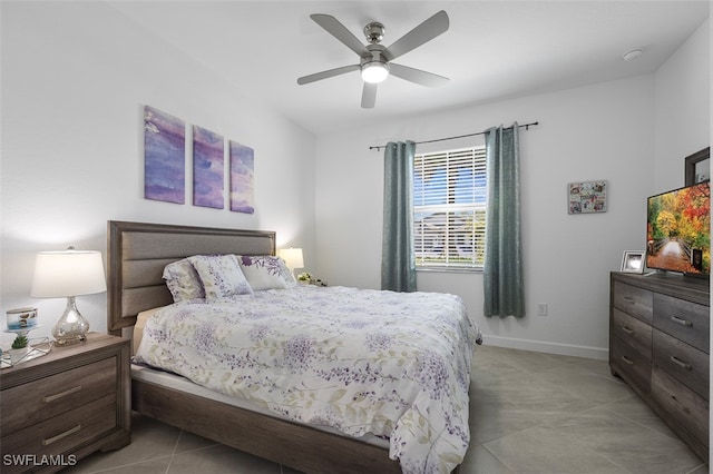 bedroom with ceiling fan and light tile patterned floors