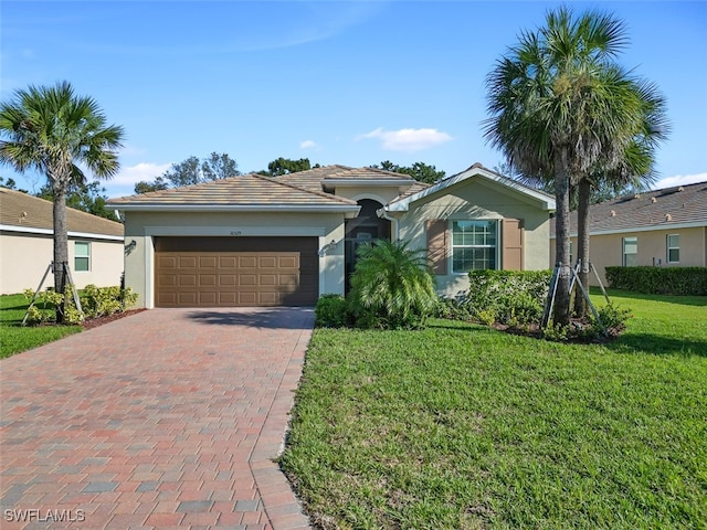 ranch-style home with a garage and a front yard