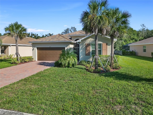 ranch-style home with a garage and a front yard