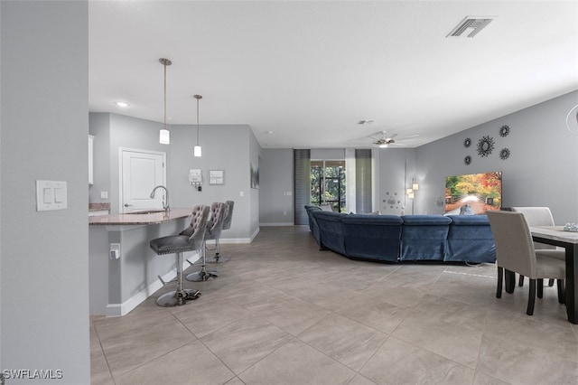 living room featuring light tile patterned flooring and ceiling fan