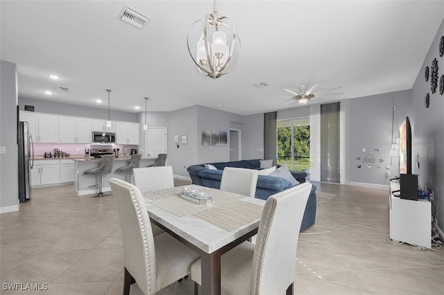 dining area with ceiling fan with notable chandelier