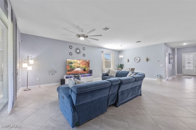 tiled living room with ceiling fan