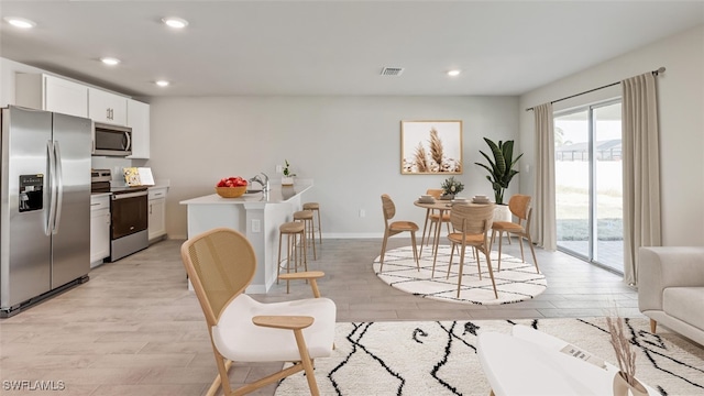 dining space featuring light hardwood / wood-style flooring