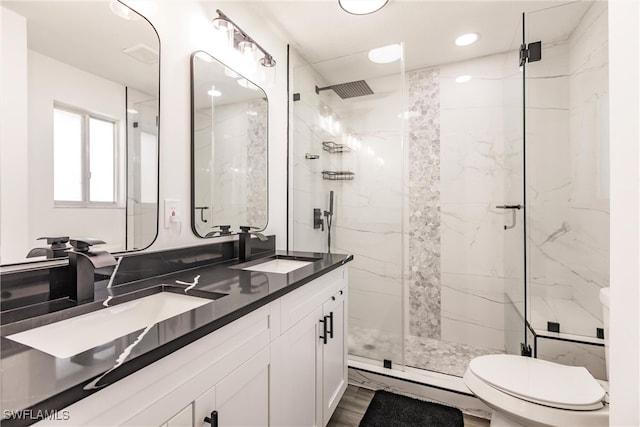 bathroom featuring vanity, toilet, a shower with door, and hardwood / wood-style flooring